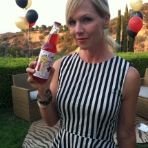 Former Beverly Hills 90210 TV star Jennie Garth holding her Rocket Fizz bottled soda pop.