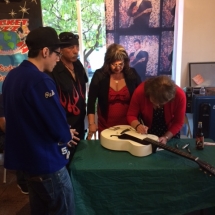 Rocket Fizz held an event honoring the late rock legend Ritchie Valens. In this photo, Ritchie&#039;s sisters Irma and Connie are autographing a guitar for a fan. Hundreds of people showed up to meet Ritchie&#039;s family and to celebrate what would have been Ritchie&#039;s 76th birthday.
